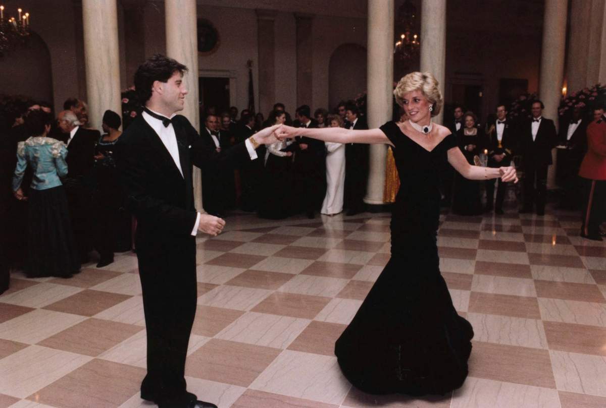 FILE – In this Nov. 9, 1985 photo provided by the Ronald Reagan Library, actor John Travolta dances with Princess Diana at a White House dinner in Washington. This outfit is featured in an exhibition of 25 dresses and outfits worn by Diana entitled “Diana: Her Fashion Story” at Kensington Palace in London, opening on Friday, Feb. 24, 2017.