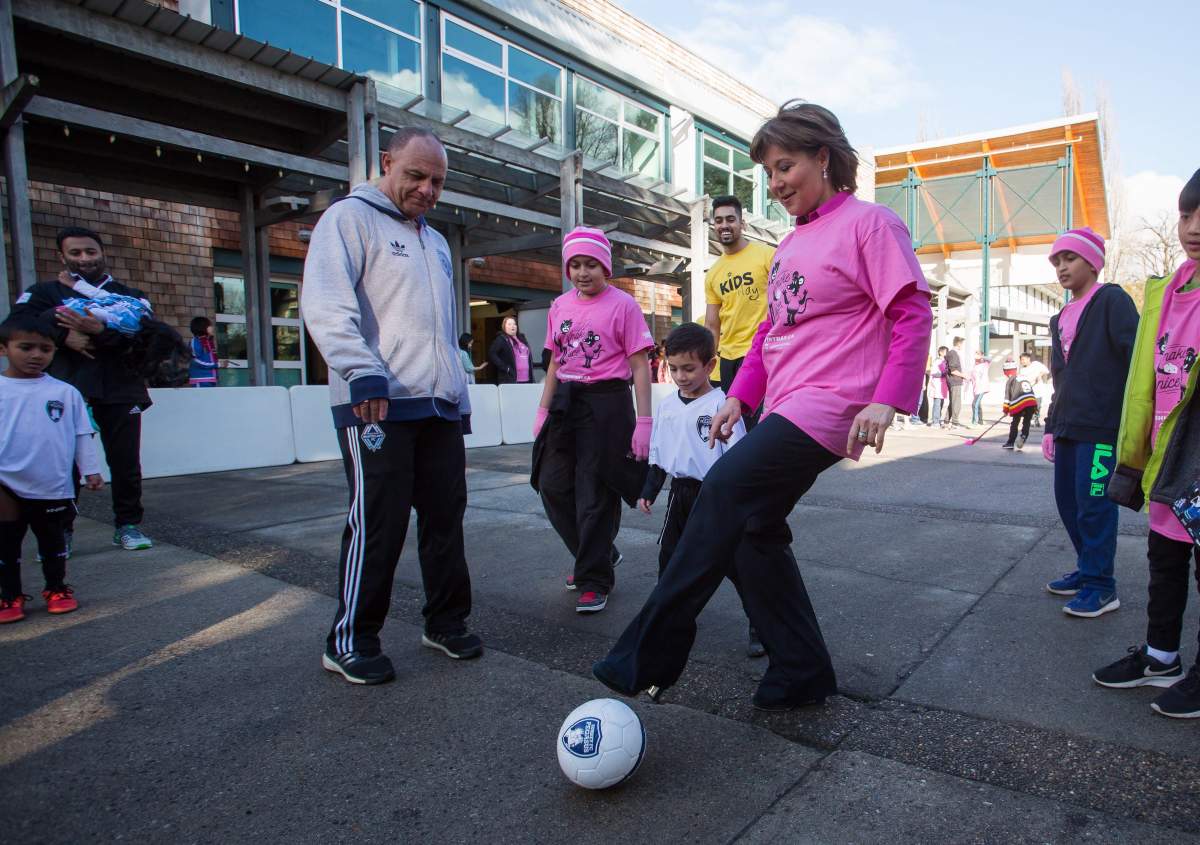 B.C Premier Christy Clark kicks a soccer ball while attending an Erase Bullying in Sport event in collaboration with Pink Shirt Anti-Bullying Day in Burnaby, B.C., on Wednesday, February 22, 2017.