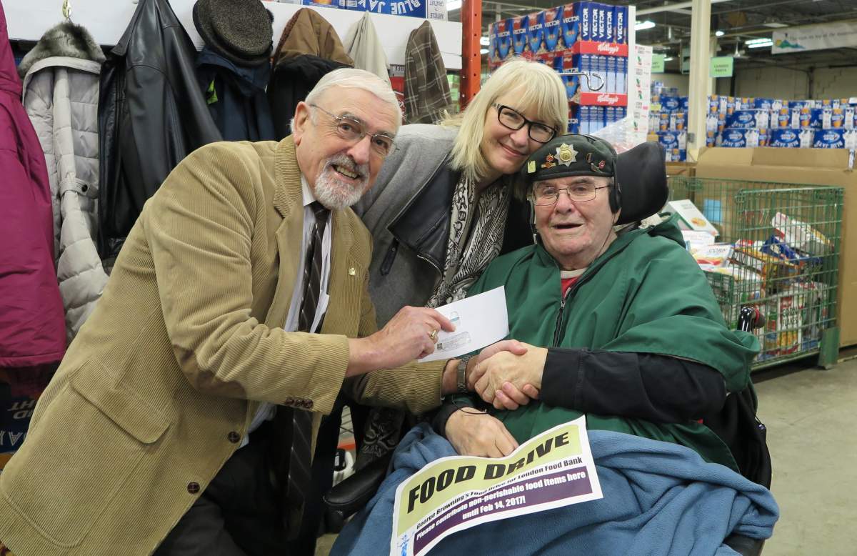 Browning, right, with daughter Brenda Bissette and London Food Bank Chair Peter Harding.