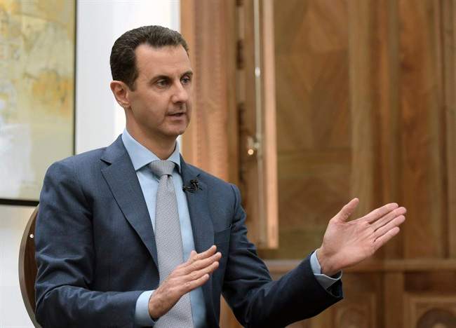 In this photo released by the Syrian official news agency SANA, Syrian President Bashar Assad speaks during an interview with Yahoo News in Damascus, Syria, Friday, Feb. 10, 2017. Assad said, there are "definitely" terrorists among the millions of Syrians seeking refuge in the West. He said it doesn't have to be a "significant" number of terrorists because no need for a significant "number to commit atrocities." (SANA via AP).