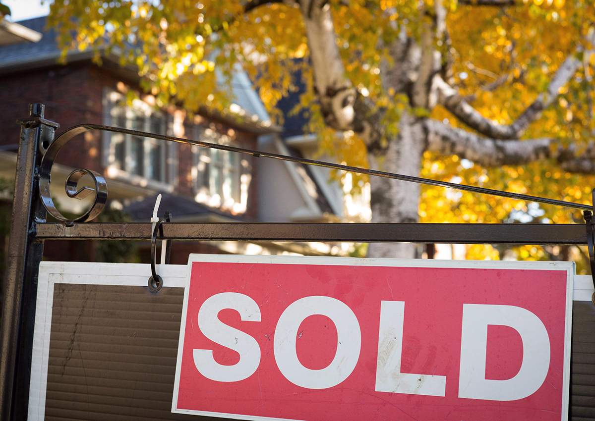 A real estate sold sign hangs in front of a west-end Toronto property Friday, Nov. 4, 2016.