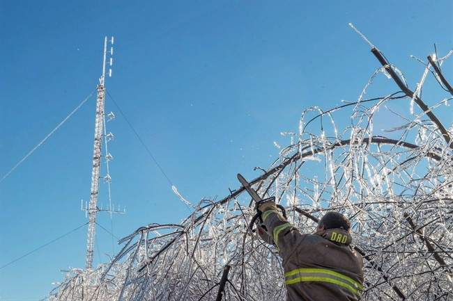 Members of the Baie Sainte Anne Fire Department clear a road so technicians can get to the emergency radio repeater tower to charge the batteries in Escuminac, N.B. on Sunday, Jan. 29, 2017. There are still about eight thousand customers awaiting the return of electricity in northern New Brunswick today, more than a week after the ice storm that wreaked havoc in the province.
