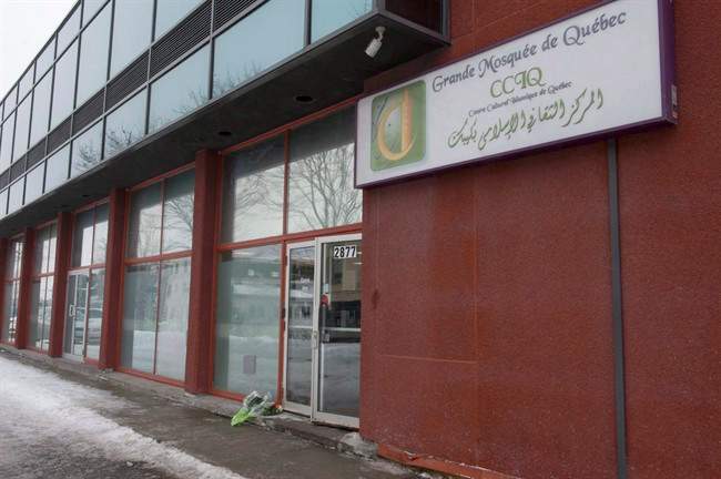 In this Feb. 2017 file photo, flowers lay at the men's entrance of the Quebec City mosque where six men were fatally shot as they attended evening prayers.