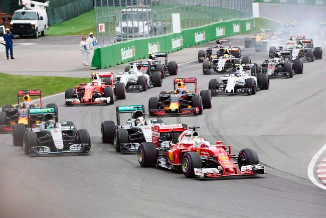 Ferrari driver Sebastian Vettel (5) of Germany leads the pack into the first chicane at the start of the Canadian Grand Prix on June 12, 2016 in Montreal.