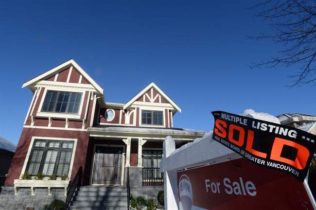 A real estate sold sign is shown outside a house in Vancouver, Tuesday, Jan.3, 2017. Home sales in Metro Vancouver last month dropped by almost 40 per cent compared with January 2016 with the sale of detached houses falling hardest.