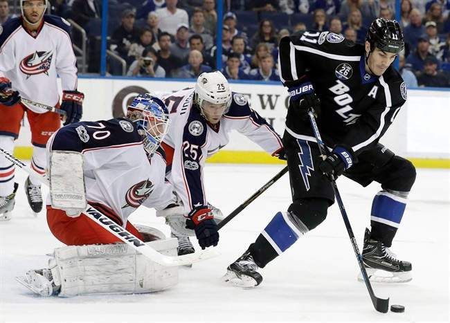 Tampa Bay Lightning centre Brian Boyle (11) takes a pass in front of Columbus Blue Jackets goaltender Joonas Korpisalo (70) and William Karlsson (25) during the second period of an NHL hockey game Friday, Jan. 13, 2017, in Tampa, Fla. The Toronto Maple Leafs have plugged a year-long hole at the fourth-line centre spot, swinging a trade with the Lightning for Boyle on Monday afternoon. 