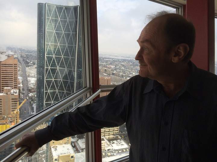 Dale Alward looking out the window of the Calgary Tower.