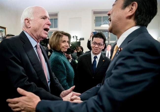 Japanese Prime Minister Shinzo Abe, right, greets House Minority Leader Nancy Pelosi of Calif., second from left, and Sen. John McCain, R-Ariz., left, at the U.S. Chamber of Commerce in Washington, Friday, Feb. 10, 2017. (AP Photo/Andrew Harnik).