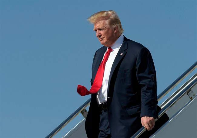 President Donald Trump walks down the steps of Air Force One as he arrives a Palm Beach International Airport in West Palm Beach, Fla., Friday, Feb. 17, 2017. 