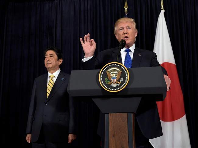 President Donald Trump speaks as Japanese Prime Minister Shinzo Abe listens as they both made statements about North Korea at Mar-a-Lago in Palm Beach, Fla., Saturday, Feb. 11, 2017.