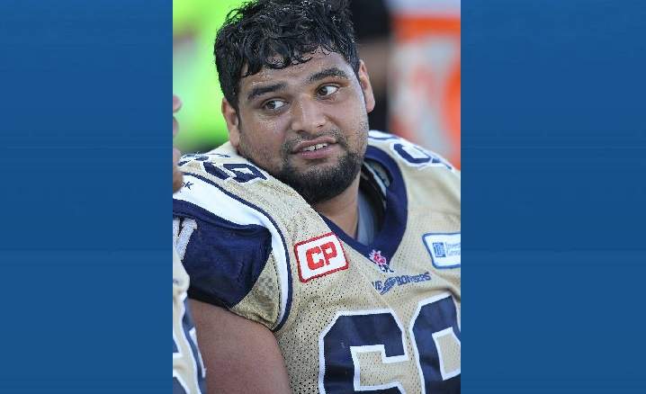 Sukh Chungh #69 of the Winnipeg Blue Bombers takes a breather against the Hamilton Tiger-Cats during a CFL football game at Tim Hortons Field on August 9, 2015 in Hamilton, Ontario, Canada. The Tiger-Cats defeated the Blue Bombers 38-8.