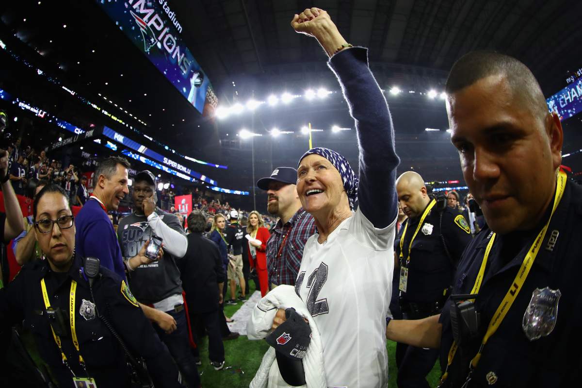 Tom Brady’s mother Galynn Brady celebrates on the field after her son led the biggest comeback in Super Bowl history Sunday night.