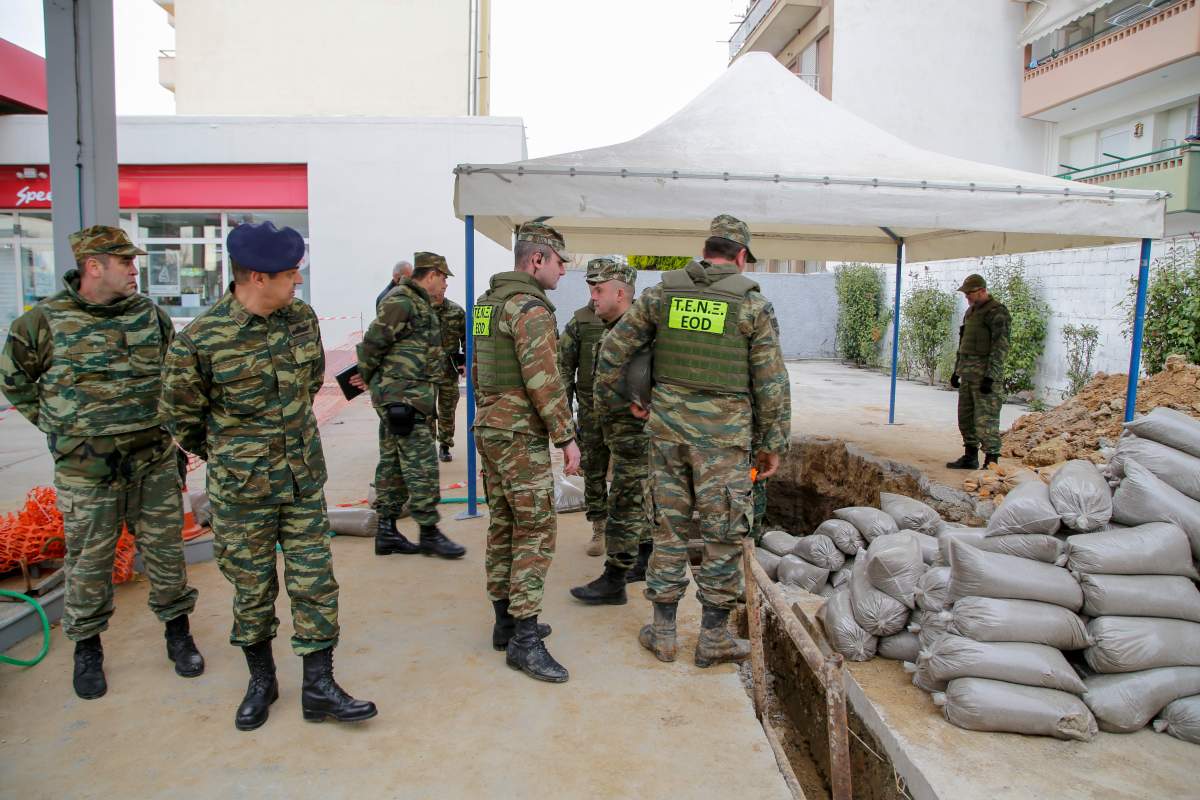 Military officers looks into the hole where an unexploded  World War II-era bomb was found on February 12, 2017 in Thessaloniki, Greece. More than 70,000  people will leave their homes in Thessaloniki during operation to defuse 250kg device. 