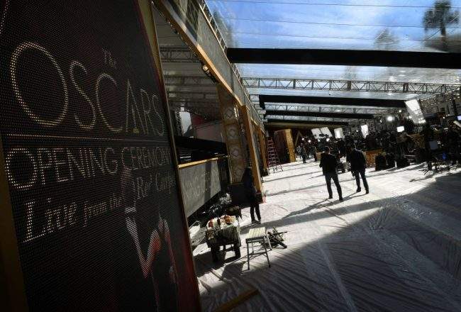 Workmen prepare the red carpet arrivals area ahead of the 89th annual Oscars outside the Dolby Theater in Hollywood, California on Feb. 24, 2017.