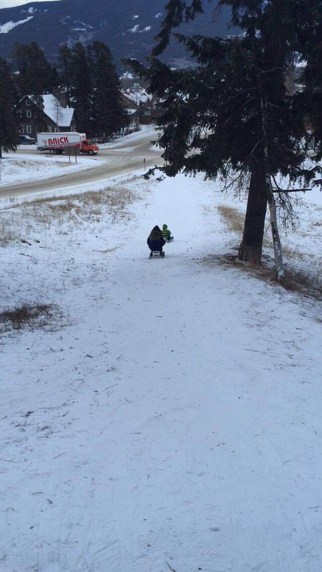 Lifelong resident Bas Byrd, 28, and his son Atreyu Byrd, 5, at popular “Church Hill” tobogganing spot in Jasper, Alta.