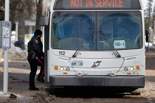 Police search for evidence at the scene of a fatal stabbing of a bus driver at the University of Manitoba in Winnipeg, Tuesday, February 14, 2017.
