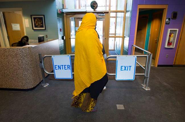 A Somali woman walks through the halls of the Pillsbury United Community Centre in Minneapolis, Minn., on Wednesday, Feb. 15, 2017. The centre is a main meeting place for the large local Somali community and is where an immigration centre has been set up to try and help people interested in leaving the United States.