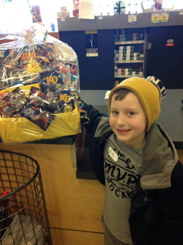 Holly Llennoco’s son, with a “Star Wars” gift basket that includes “Star Wars” KD boxes.
