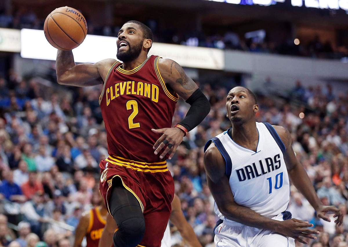 Cleveland Cavaliers guard Kyrie Irving (2) battles past Dallas Mavericks guard Yogi Ferrell (10) for a layup during the first half of an NBA basketball game, Monday, Jan. 30, 2017, in Dallas. 