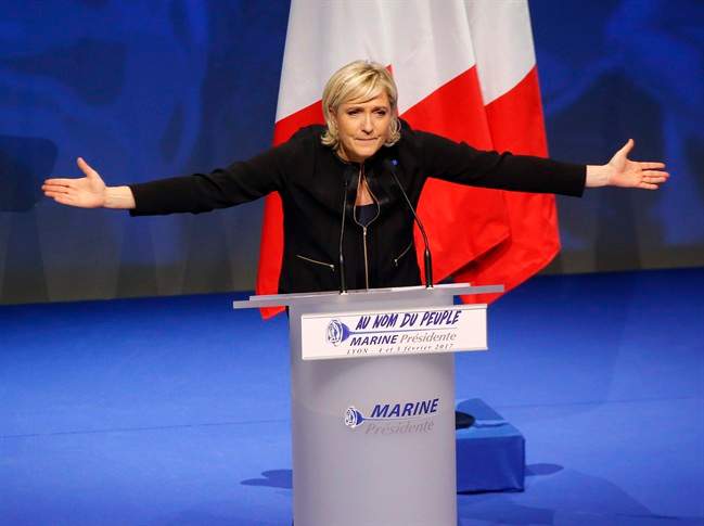 FILE - In this Sunday, Feb. 5, 2017 file photo, Far-right leader presidential candidate Marine Le Pen gestures as she speaks during a conference in Lyon, France. If Marine Le Pen has her way, the French will soon pay for their baguettes with francs, not euros. The presidential candidate from the anti-EU, anti-immigration National Front party is all about national sovereignty and independence. She wants France to take control of its money, subject to a referendum that would lead France out of the European Union and its shared currency. (AP Photo/Michel Euler, file).