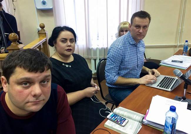 In this handout photo provided by Alexei Navalny press service Russian opposition leader Alexei Navalny, right, his former colleague Pyotr Ofitserov, left, and lawyer Svetlana Davydov, second left, sit in a courtroom in Kirov, Russia, Wednesday, Feb. 1, 2017.