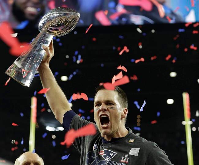 New England Patriots' Tom Brady hoists the Vince Lombardi Trophy after the NFL Super Bowl 51 football game against the Atlanta Falcons Sunday, Feb. 5, 2017, in Houston. The New England Patriots won 34-28 in overtime.