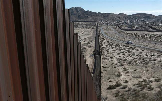 A truck drives near the Mexico-US border fence, on the Mexican side, separating the towns of Anapra, Mexico and Sunland Park, New Mexico, Jan. 25, 2017.