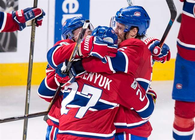 Montreal Canadiens' Shea Weber, right, and Brendan Gallagher, left, hug teammate Alex Galchenyuk.