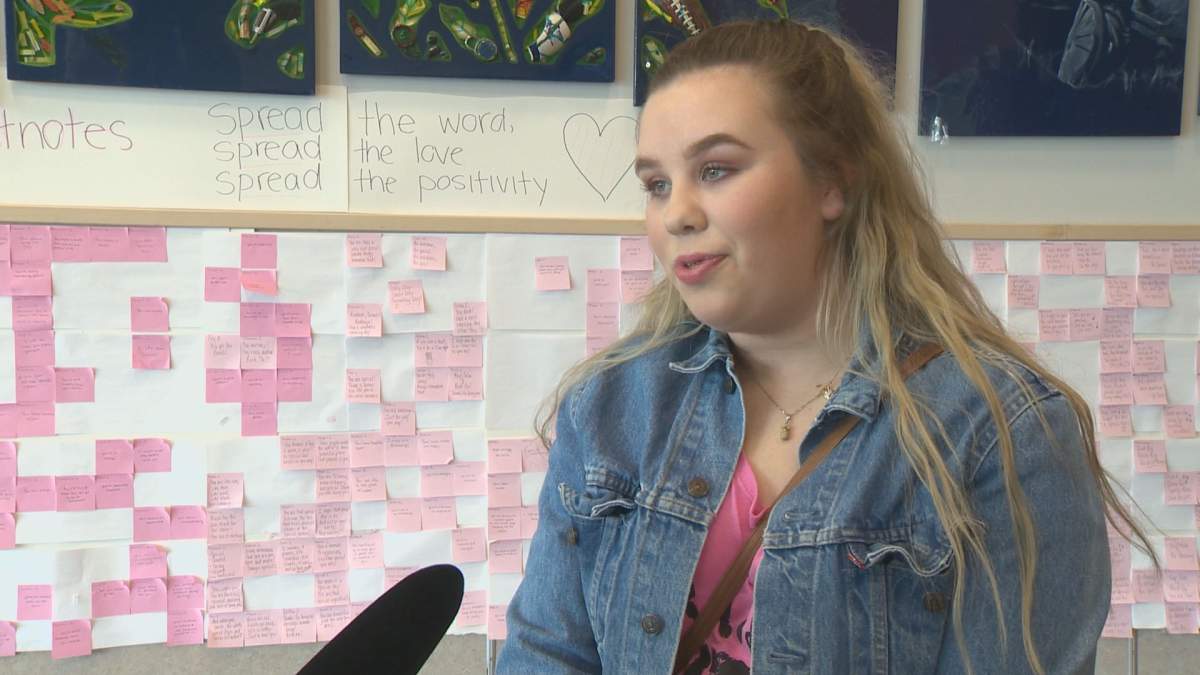 Shaughnessy Barker stands in front of the wall of complements she helped write for her classmates. 