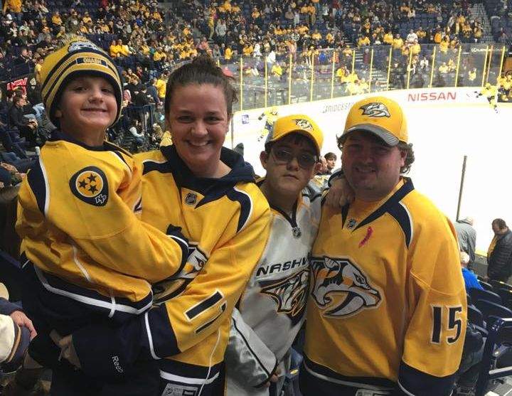Christopher Smith (R) with his fiancee and two kids from their church at the Nashville Predators game Thursday, Feb. 2, 2017. Two Edmonton Oilers fans bought Zeb (L) a gold Predators jersey, out of the kindness of their hearts.