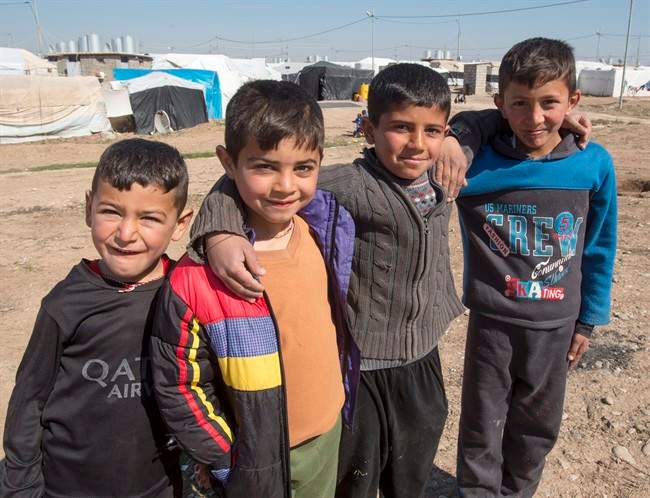 A group of Yazidi boys pose for a photo at a camp for internal displaced persons, Wednesday, February 22, 2017 in Dohuk, Iraq. 