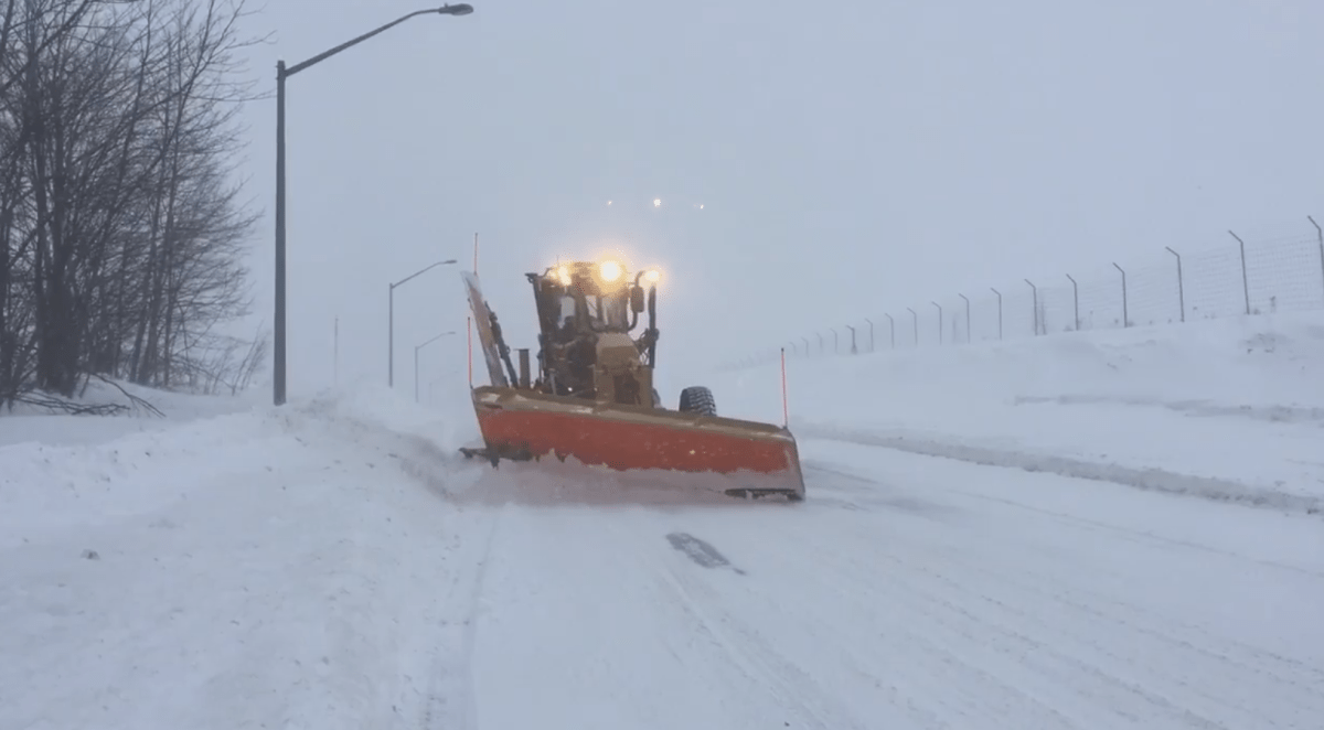 A snow plow makes its way down a street, during a blizzard in New Brunswick on Monday, Feb. 13, 2017.  