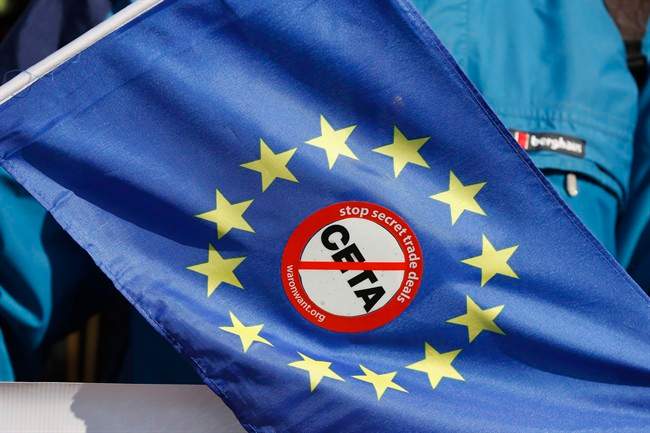 An anti-CETA sticker is pictured on an European flag during a demonstration against the so-called CETA trade deal outside the European Parliament in Strasbourg, eastern France, Wednesday, Feb.15, 2017.