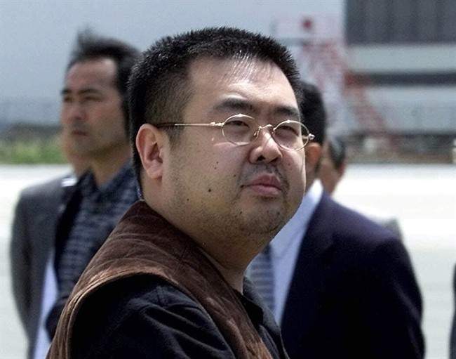 In this May 4, 2001, file photo, a man believed to be Kim Jong Nam, the eldest son of then North Korean leader Kim Jong Il, looks at a battery of photographers as he exits a police van to board a plane to Beijing at Narita international airport in Narita, northeast of Tokyo.