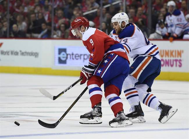 Edmonton Oilers right wing Zack Kassian (44) chases down Washington Capitals defenseman Dmitry Orlov (9), of Russia, for the puck during first period of an NHL hockey game, Friday, Feb. 24, 2017, in Washington. 