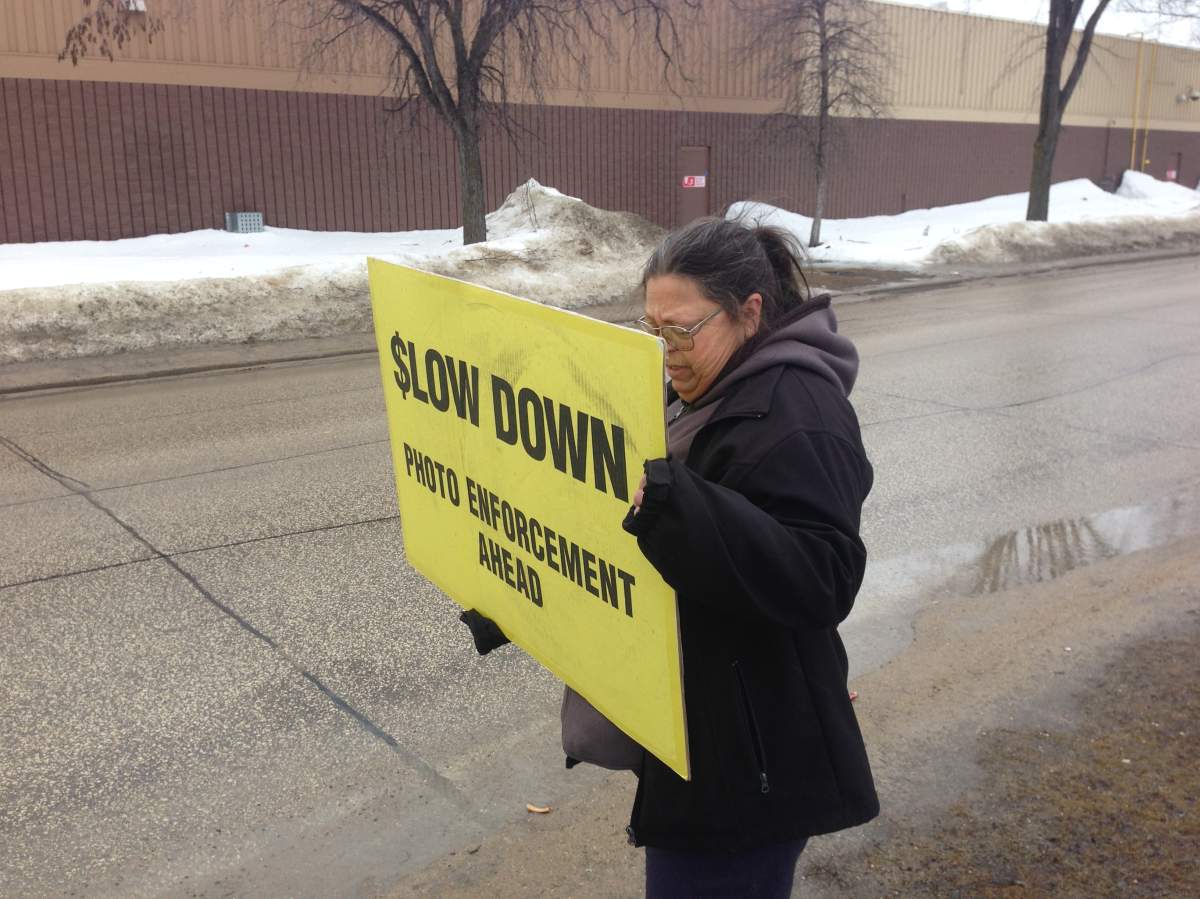 Other WiseUp Winnipeg members were out on the streets Monday morning with signs to warn drivers.