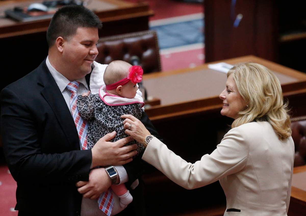Oklahoma state Sen. Kim David, left, R-Porter, greets five-month-old Evelyn Shortey, center, the daughter of Oklahoma state Sen. Ralph Shortey, left, R-Oklahoma City, on the House floor in Oklahoma City, Monday, Feb. 3, 2014.