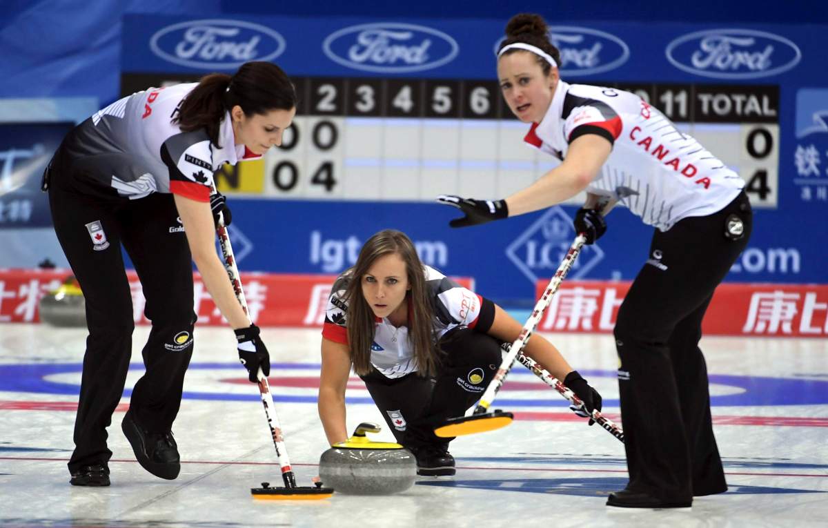 Rachel Homan, center, of Canada throws a curling stone in a match against China during the CPT World Women's Curling Championship 2017 (WWCC) in Beijing, China Saturday March 18, 2017. Canada won by 9-3. 