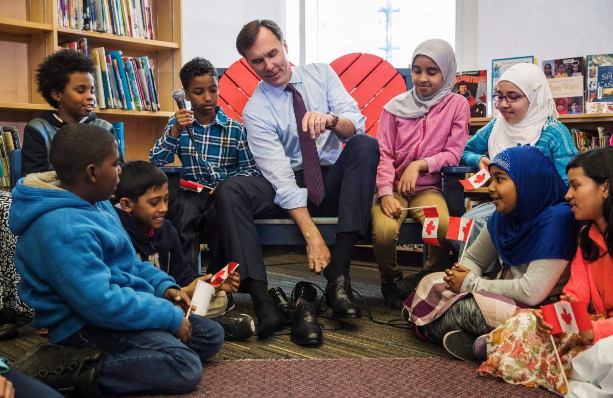 Canada’s federal Finance Minister Bill Morneau takes part in the pre-budget ceremony of putting on new shoes at the Nelson Mandela Park Public School in Toronto, Monday March 20, 2017.