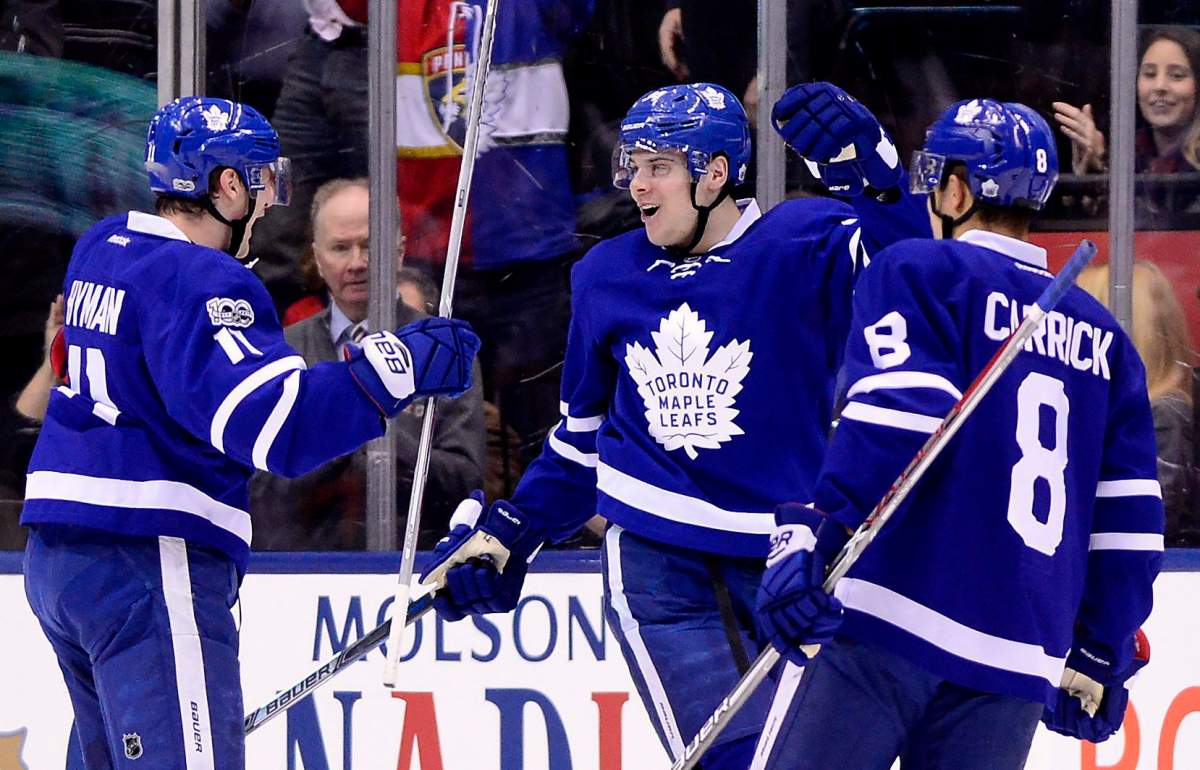 Toronto Maple Leafs centre Auston Matthews celebrates his goal with teammates Zach Hyman and Connor Carrick during first period NHL hockey action, in Toronto on Tuesday, March 28, 2017.