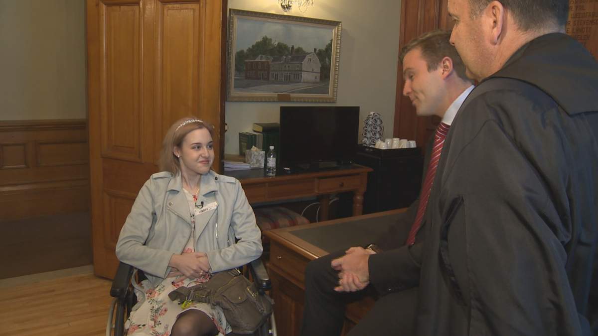 Becca Schofield speaks with New Brunswick Premier Brian Gallant and other members of the legislature in Fredericton on Tuesday, March 14, 2017.