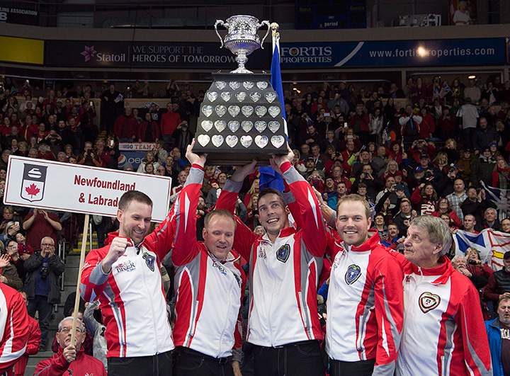 Newfoundland and Labrador\’s Brad Gushue, Mark Nichols, Brett Gallant, Geoff Walker and coach Jules Owchar, left to right, hold the Brier Tankard after defeating Team Canada 7-6 at Mile One Centre in St. John\’s on Sunday, March 12, 2017.