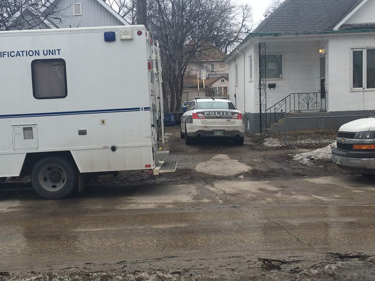 Winnipeg police remain at this home on Burrows Avenue. 