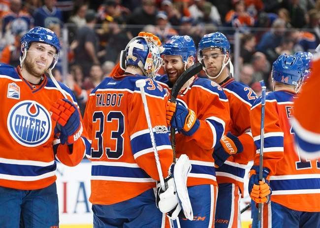 Edmonton Oilers' goalie Cam Talbot (33) is congratulated on a shutout win by teammate Zack Kassian (44) after defeating the Vancouver Canucks 2-0 following third period NHL hockey action in Edmonton on Saturday, March 18, 2017. 