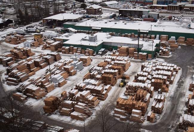 A worker uses a forklift to move lumber at Delta Cedar Products in Delta, B.C., on Friday January 6, 2017.