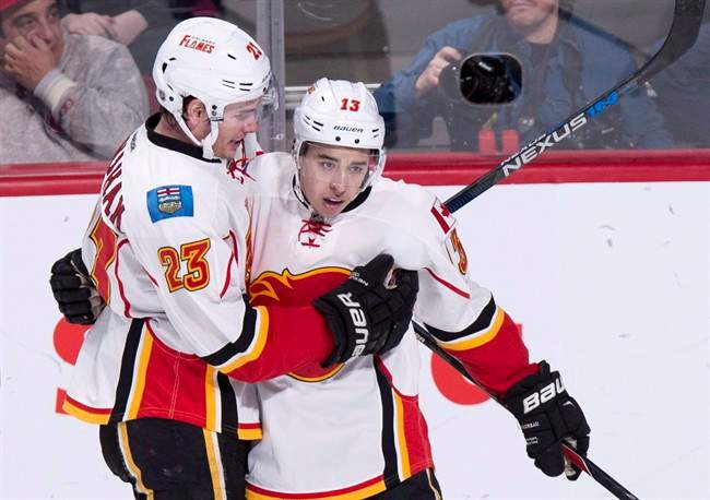 Calgary Flames' Johnny Gaudreau, right, celebrates his goal against the Montreal Canadiens with teammate Sean Monahan during third period NHL hockey action Sunday, March 20, 2016 in Montreal.