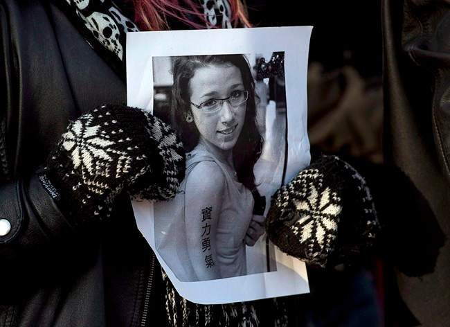 A woman holds a photo as several hundred people attended a community vigil to remember Rehtaeh Parsons at Victoria Park in Halifax on Thursday, April 11, 2013. THE CANADIAN PRESS/Andrew Vaughan