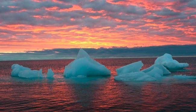 Ice chunks float in the Arctic Ocean as the sun sets near Barrow, Alaska, Sept. 13, 2006.