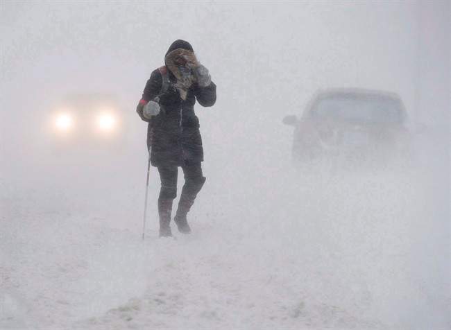A pedestrian walks down Brunswick Street near Citadel Hill in Halifax as a major winter storm blasts the Maritimes on Monday, Feb. 13, 2017. 
