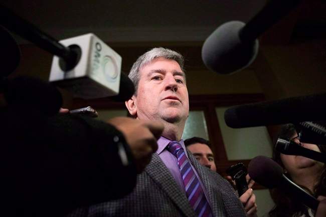 Glen Murray talks to media at Queens Park in Toronto on Thursday, December 12, 2013.
